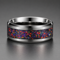 Silver ring with a colorful speckled band on a gray background